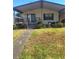Cozy single-story home featuring covered entrance, well-maintained lawn, and landscaped garden beds at 612 Forest Lake Dr, Lakeland, FL 33809