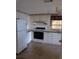 Functional kitchen with white cabinets, black appliances, and ample counter space, illuminated by a skylight at 612 Forest Lake Dr, Lakeland, FL 33809