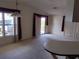 Bright living room with large windows and sliding glass door, featuring neutral carpet and high ceilings at 612 Forest Lake Dr, Lakeland, FL 33809