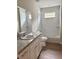 Bright bathroom features a modern vanity and shower with white subway tile at 625 W 9Th St, Lakeland, FL 33805