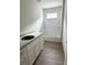 Bathroom with a tub and shower combo with white subway tile and white vanity with stone countertop at 625 W 9Th St, Lakeland, FL 33805