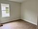 This bedroom features a light paint, natural lighting, and wood-look laminate flooring at 625 W 9Th St, Lakeland, FL 33805