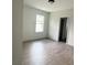 Bedroom featuring luxury vinyl plank flooring and a bright window at 625 W 9Th St, Lakeland, FL 33805