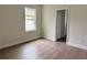 Bright bedroom features a window for natural light and wood-look laminate flooring at 625 W 9Th St, Lakeland, FL 33805