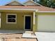 Charming house with a well-manicured lawn, a driveway leading to an attached garage at 625 W 9Th St, Lakeland, FL 33805
