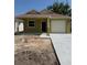 Charming one-story home featuring a covered entryway, attached garage, and light-colored exterior at 625 W 9Th St, Lakeland, FL 33805