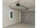 A clean, spacious garage with an automatic door and electrical panel at 625 W 9Th St, Lakeland, FL 33805