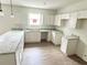 Bright kitchen with white cabinets, granite countertops, and LVP flooring at 625 W 9Th St, Lakeland, FL 33805