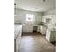 Bright kitchen with white cabinets, granite countertops, and LVP flooring at 625 W 9Th St, Lakeland, FL 33805