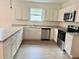 Bright kitchen features white cabinetry, stainless steel appliances, and light countertops at 625 W 9Th St, Lakeland, FL 33805