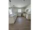 Well-lit kitchen with sleek white cabinetry, granite countertops, and modern pendant lighting at 625 W 9Th St, Lakeland, FL 33805
