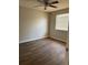 Cozy bedroom featuring wood-look floors, ceiling fan, neutral paint, and natural light at 629 W 9Th, Lakeland, FL 33805