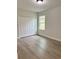 Cozy bedroom with a closet, wood-look floors, and a window offering natural light at 629 W 9Th, Lakeland, FL 33805