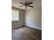 Bright bedroom featuring wood-look floors, ceiling fan, neutral paint, and natural light at 629 W 9Th, Lakeland, FL 33805