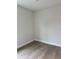 A bedroom with hardwood flooring, neutral paint, modern baseboards, and simple design at 629 W 9Th, Lakeland, FL 33805