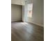Bedroom with closet, window and wood-look floors. Closet has wire shelving at 629 W 9Th, Lakeland, FL 33805