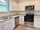 Modern kitchen featuring white cabinets, stainless steel appliances, and ample counter space at 629 W 9Th, Lakeland, FL 33805
