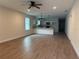 Open living space featuring a ceiling fan, wood-look floors, and an open layout to the kitchen at 629 W 9Th, Lakeland, FL 33805