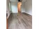 Inviting living room featuring wood-look floors and neutral paint, flowing into the hallway at 629 W 9Th, Lakeland, FL 33805