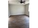Spacious living room featuring wood-look floors, ceiling fan, neutral paint, and natural light at 629 W 9Th, Lakeland, FL 33805