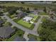 Aerial view of this home showcases its location in a community with a lake view and mature trees at 647 Hart Lake Dr, Winter Haven, FL 33884