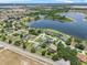Beautiful aerial view of lakeside homes, lush landscaping, and serene water features in a desirable neighborhood at 647 Hart Lake Dr, Winter Haven, FL 33884