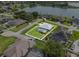 Aerial view of this home reveals a private backyard oasis with a swimming pool, surrounded by a well-maintained lawn at 647 Hart Lake Dr, Winter Haven, FL 33884