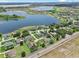 An aerial view of a quiet, lakeside community with lush, mature trees and well-maintained green spaces at 647 Hart Lake Dr, Winter Haven, FL 33884