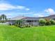 Lush green lawn and landscaping surround this home, and it is fully enclosed with a white vinyl fence at 647 Hart Lake Dr, Winter Haven, FL 33884