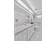 Bright bathroom with white cabinets, marble countertops, a toilet, and a shower with curtains at 647 Hart Lake Dr, Winter Haven, FL 33884