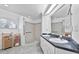 Bright bathroom features double sinks, a walk-in shower, and a storage rack with neatly folded towels at 647 Hart Lake Dr, Winter Haven, FL 33884