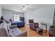 This bedroom includes 2 sitting chairs, hardwood floors, and a ceiling fan at 647 Hart Lake Dr, Winter Haven, FL 33884