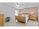 Serene bedroom with tiled floors, complemented by soft lighting and comfortable furnishings at 647 Hart Lake Dr, Winter Haven, FL 33884