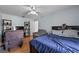 Spacious bedroom with hardwood floors, dark furniture, and a cozy sitting area at 647 Hart Lake Dr, Winter Haven, FL 33884