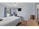 Sunlit bedroom with a tv on the wall, ceiling fan, and wood floors at 647 Hart Lake Dr, Winter Haven, FL 33884