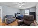 This bedroom has hard wood floors, ceiling fan, and 2 lounging chairs at 647 Hart Lake Dr, Winter Haven, FL 33884