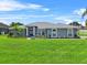 Charming single-story home featuring a well-manicured lawn and beautiful landscaping at 647 Hart Lake Dr, Winter Haven, FL 33884