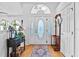 Bright foyer features a decorative glass door, wood floors, and stylish decor at 647 Hart Lake Dr, Winter Haven, FL 33884