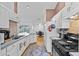 Bright kitchen with white cabinets, appliances, and a view into the dining area at 647 Hart Lake Dr, Winter Haven, FL 33884