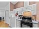 Kitchen with white cabinetry, black appliances, and an eat-in area at 647 Hart Lake Dr, Winter Haven, FL 33884