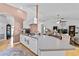 Open kitchen featuring white cabinets, a breakfast bar, and seamless flow into the living area at 647 Hart Lake Dr, Winter Haven, FL 33884