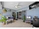 Relaxing covered patio with comfortable seating, plants, and a ceiling fan at 647 Hart Lake Dr, Winter Haven, FL 33884