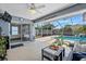 Inviting covered patio with a ceiling fan, outdoor furniture, and a view of the sparkling pool at 647 Hart Lake Dr, Winter Haven, FL 33884