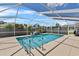 Inviting screened-in pool with clear blue water and a relaxing waterfall feature at 647 Hart Lake Dr, Winter Haven, FL 33884
