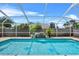 This in ground pool has clear blue water and a Personal made waterfall feature at 647 Hart Lake Dr, Winter Haven, FL 33884