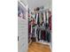 Walk-in closet with custom shelving, drawers, and hanging rods that maximizes storage space at 647 Hart Lake Dr, Winter Haven, FL 33884