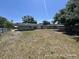 Large, unfenced backyard with a concrete patio, providing ample space for outdoor activities and landscaping at 6610 Chippendale Rd, Lakeland, FL 33809