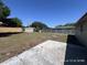 A view of the large backyard with a concrete patio, metal shed, and partial fencing at 6610 Chippendale Rd, Lakeland, FL 33809
