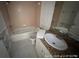 Cozy bathroom with a sink, toilet, and bathtub with showerhead at 6610 Chippendale Rd, Lakeland, FL 33809