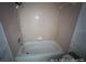 Bathroom bathtub with mounted showerhead and simple faucet at 6610 Chippendale Rd, Lakeland, FL 33809
